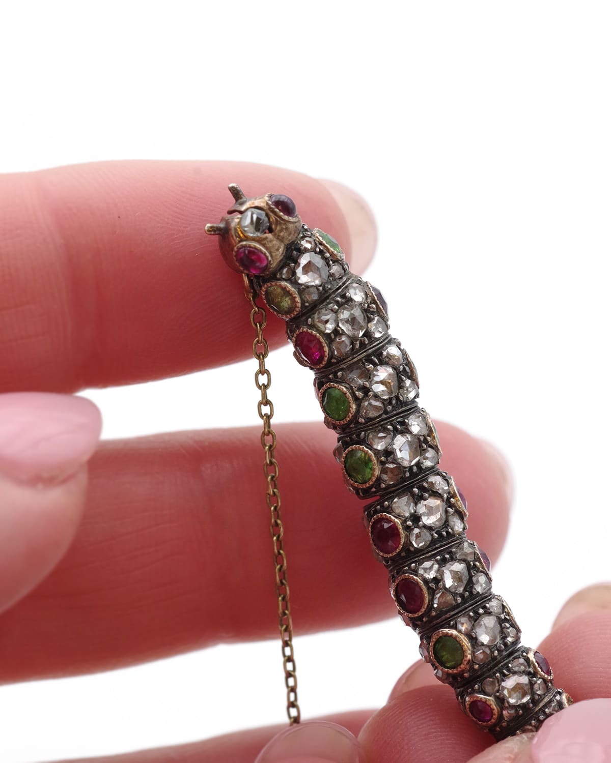 Demantoid garnet and ruby caterpillar brooch