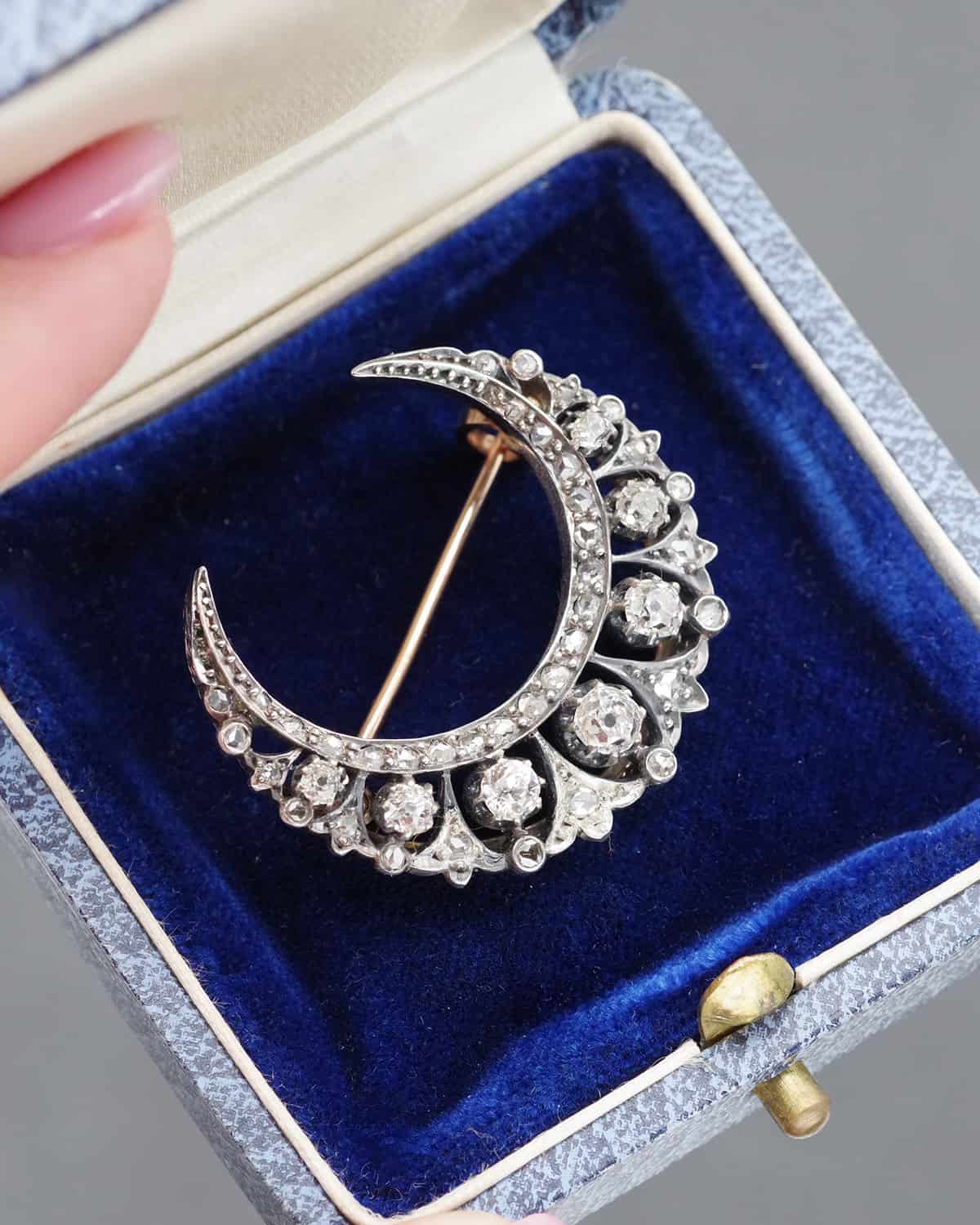 Crescent moon brooch with diamonds