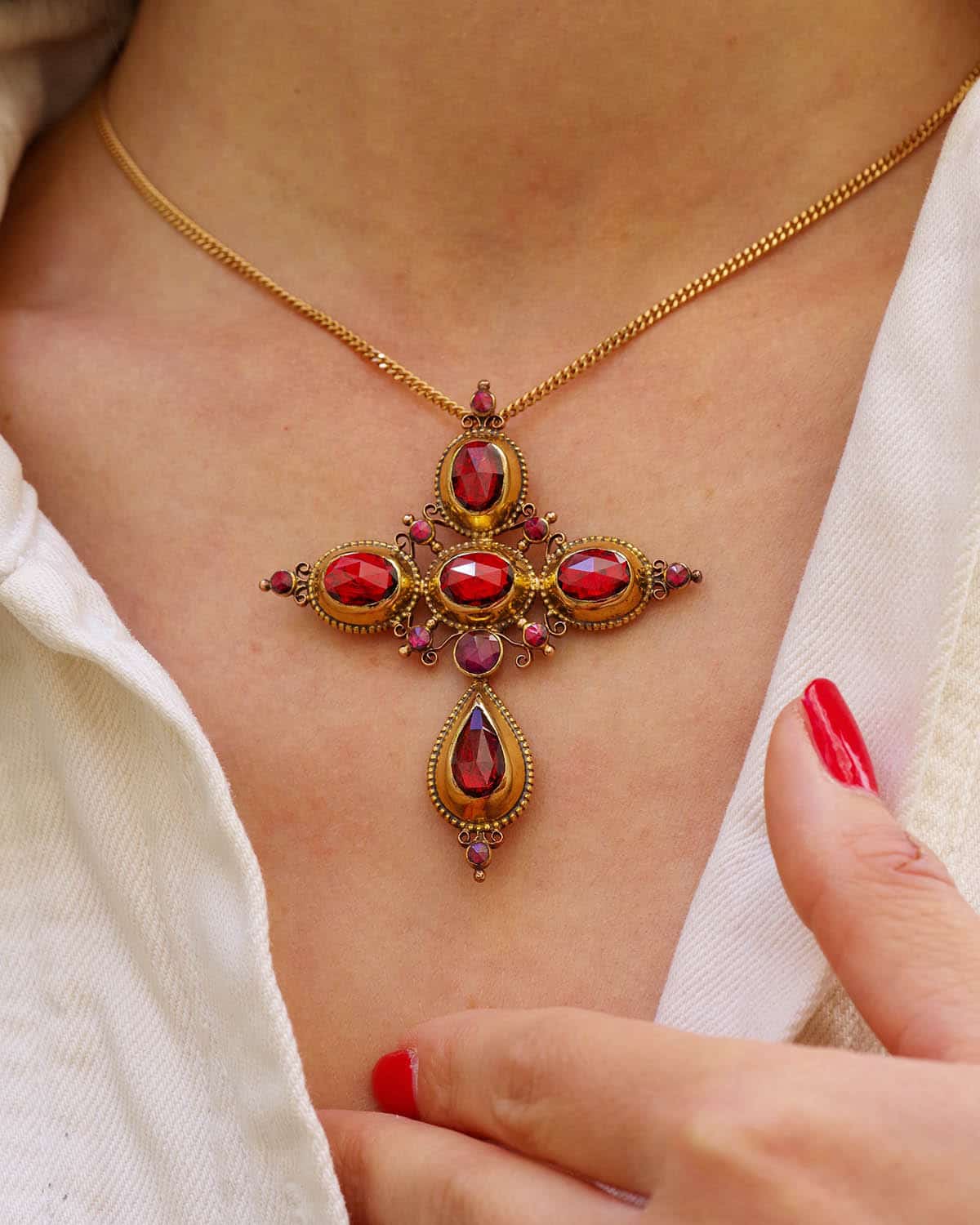 Garnet gold cross pendant