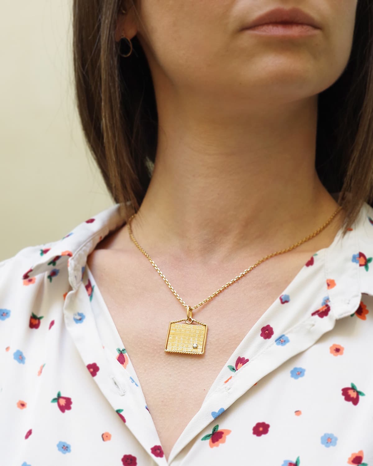 March calendar gold pendant