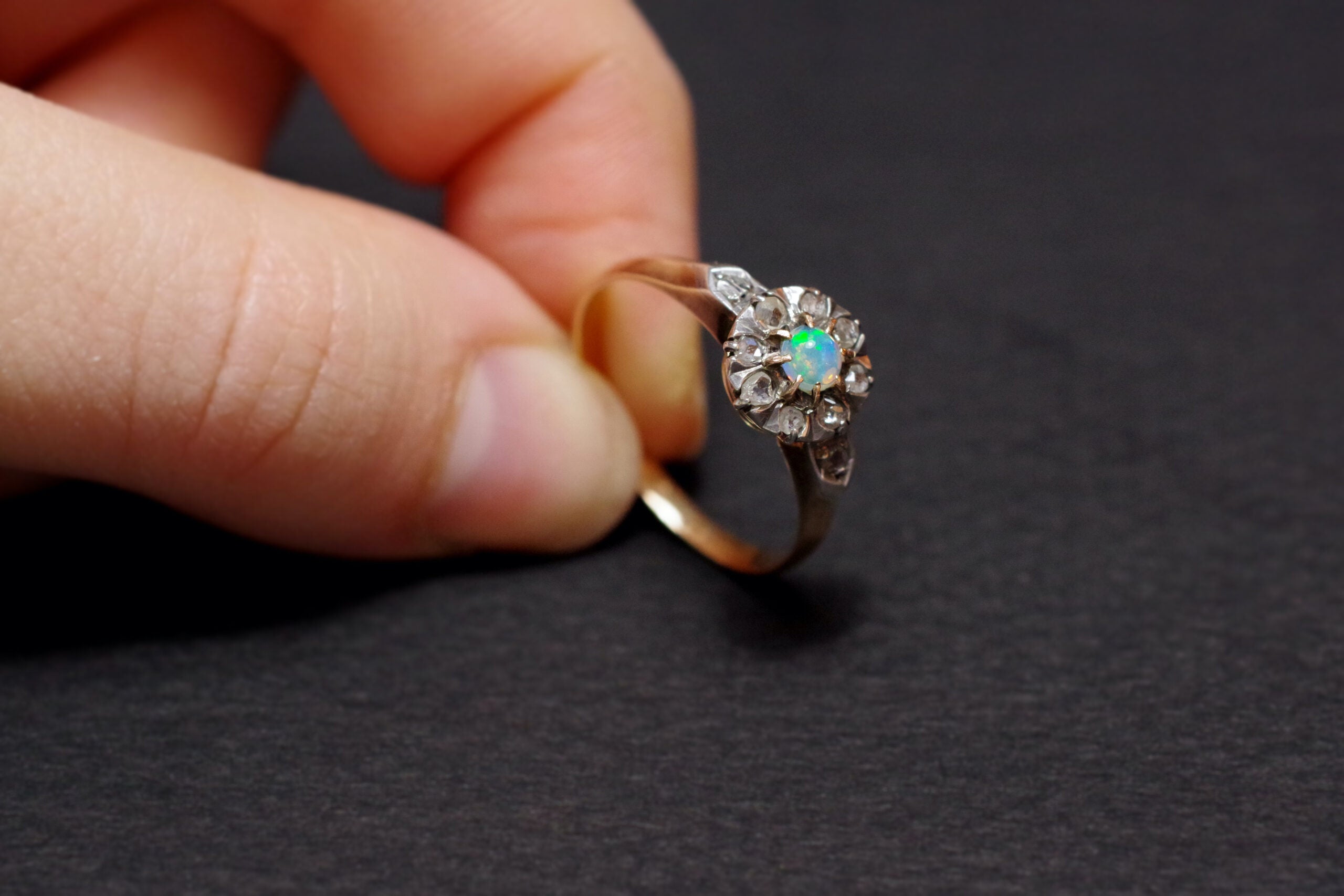 antique cluster ring with an opal and diamonds