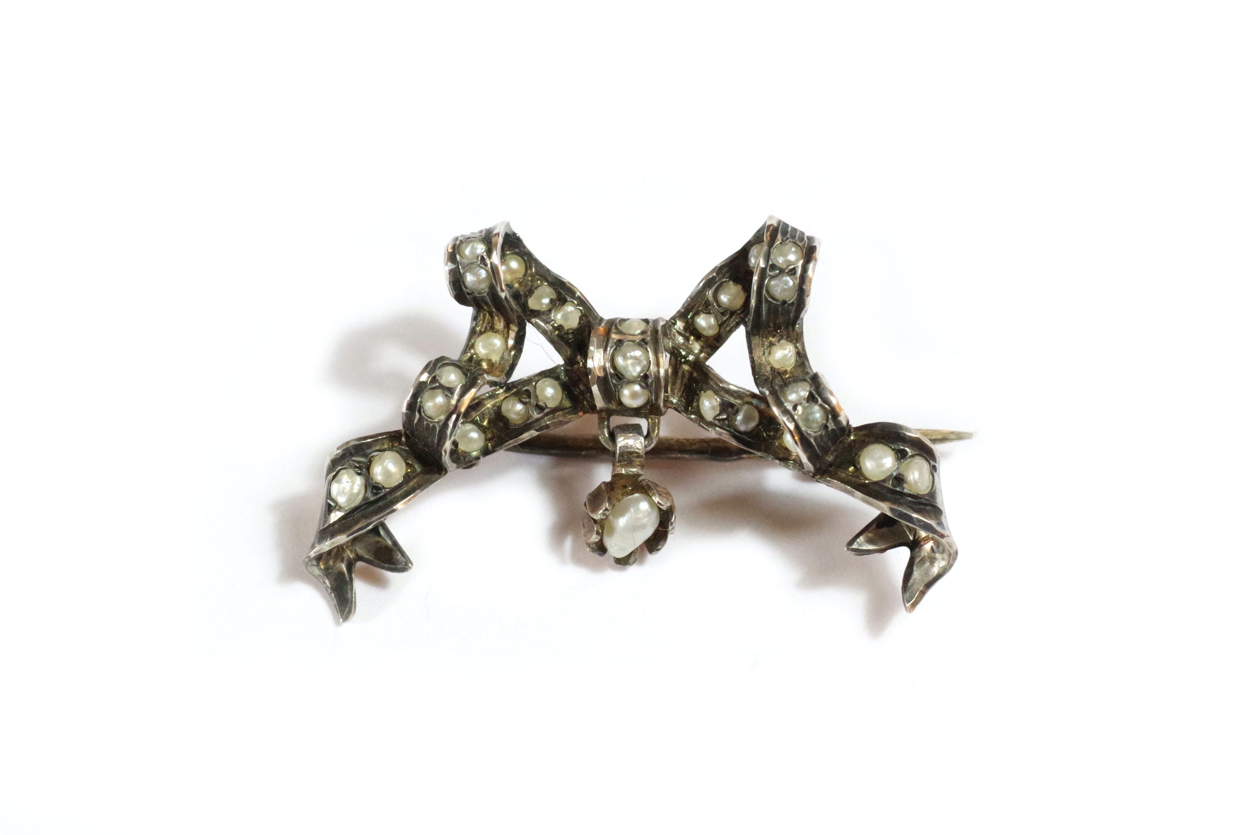 antique pearl brooch in silver knot shape