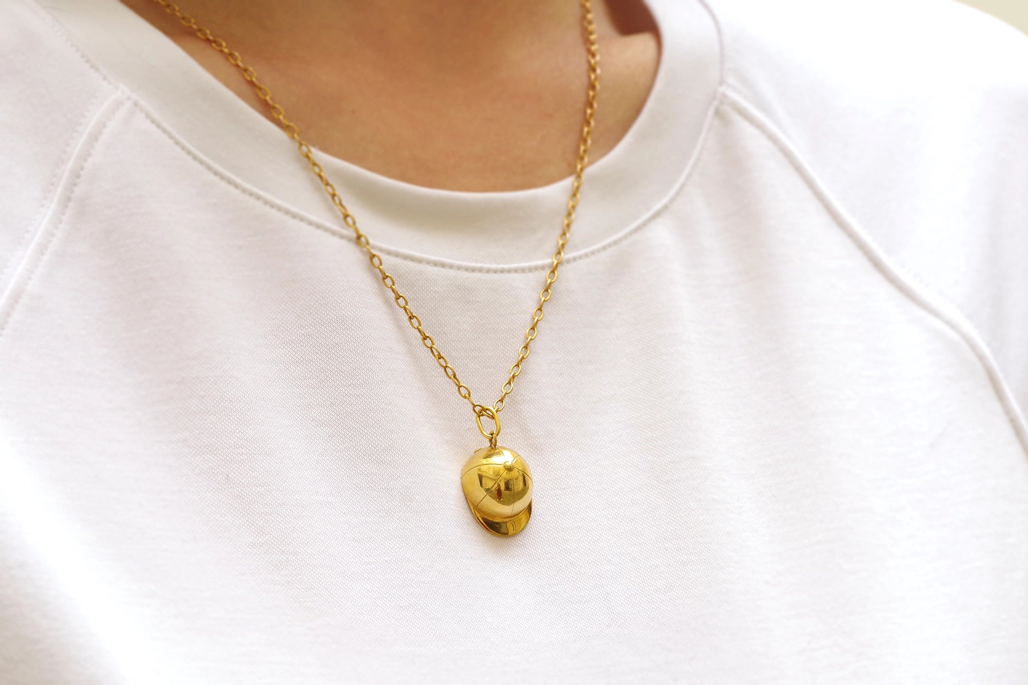 helmet riding gold pendant