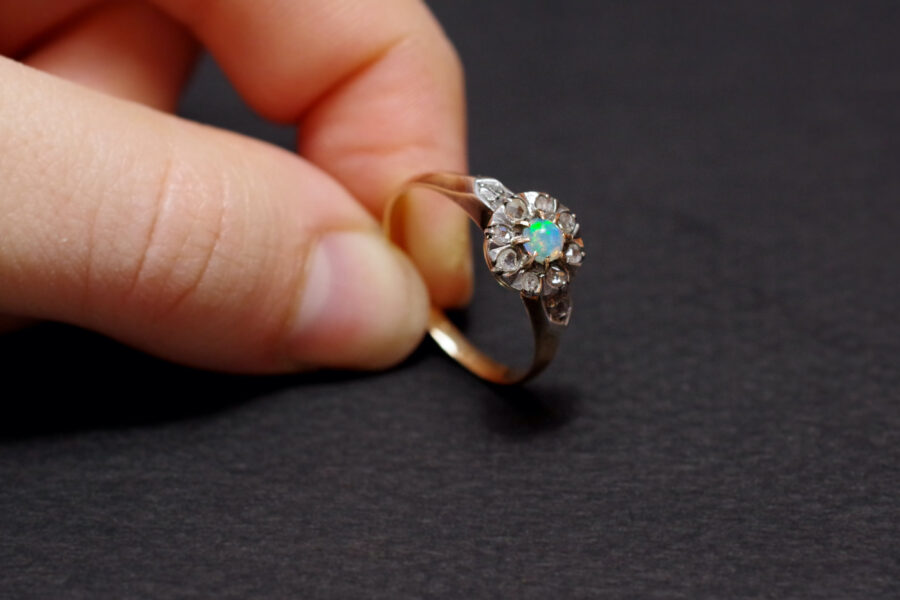 antique cluster ring with an opal and diamonds