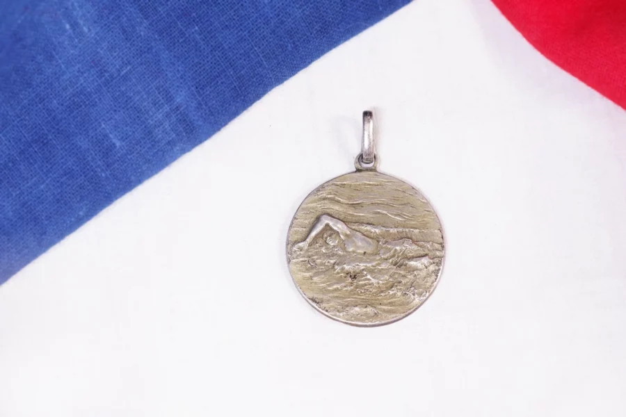 Antique swimmer medal pendant